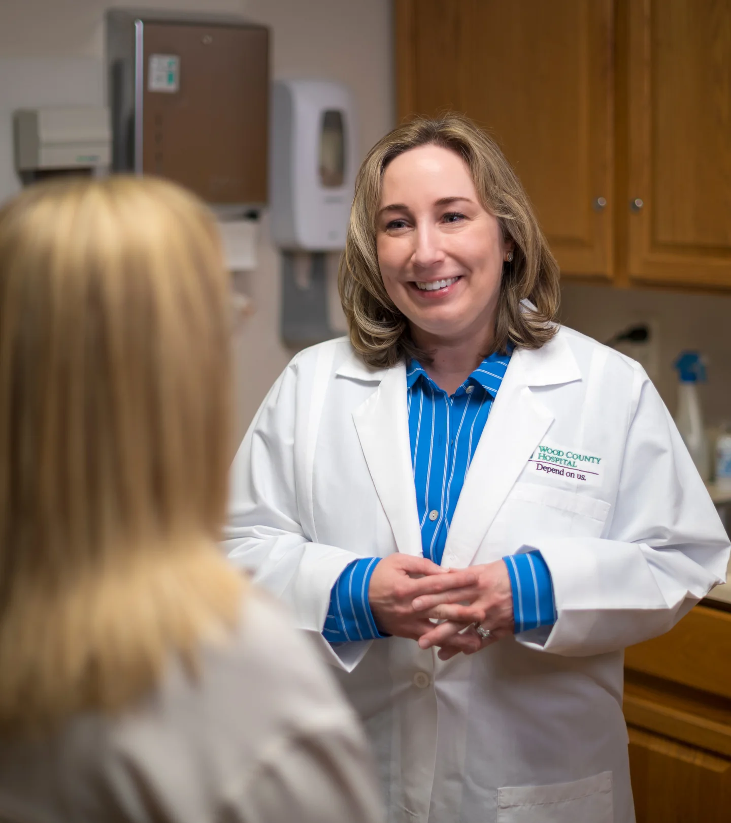 A Wood County Hospital physician with a patient